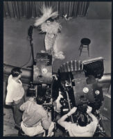 Claudette Colbert with film crew on the set of Zaza