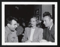 Unidentified serviceman, Lauren Bacall, and Charles Boyer on the set of Confidential Agent