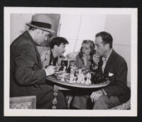 Charles Boyer, Herman Steiner, Lauren Bacall, and Humphrey Bogart on the set of Confidential Agent