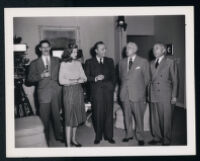 Lauren Bacall, Charles Boyer, and unidentified men on the set of Confidential Agent