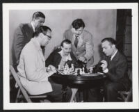Argentinian chess Master Herman Pilnik plays a game with actor Charles Boyer on the set of Confidential Agent