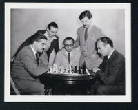 Charles Boyer and several Chess Masters on the set of Confidential Agent