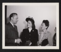 Charles Boyer and two women on the set of Confidential Agent