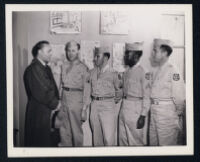 Charles Boyer and four visiting servicemen on the set of Confidential Agent