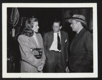 Lauren Bacall, unidentified man, and Charles Boyer on the set of Confidential Agent