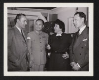 Charles Boyer, Katina Paxinou, and unidentified men on the set of Confidential Agent