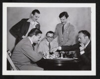 Charles Boyer with international chess masters on the set of Confidential Agent