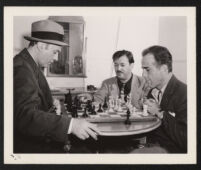 Charles Boyer, Herman Steiner, and Humphrey Bogart on the set of Confidential Agent