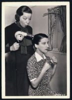 Friend Fanny Brice helps Beatrice Lillie on the set of Doctor Rhythm.