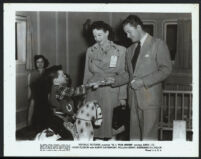 Actress Anna Lee with an unidentified man and child on the set of G.I. War Brides