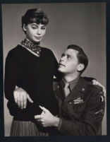 Leslie Caron and a uniformed John Kerr on the set of Gaby