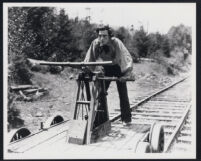 Buster Keaton drives a two-man, railroad handcar in The General
