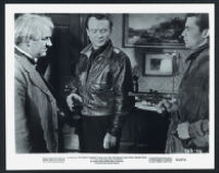 Joseph Tomelty and John Mills look cautiously at the gun of Dirk Bogarde in The Gentle Gunman