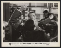 Tab Hunter punches his way through a barracks fight scene with cast members in The Girl He Left Behind