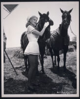 Marie Wilson with horses on the set of A Girl in Every Port