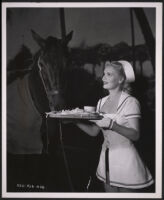 Marie Wilson inadvertently feeds a horse in a scene from A Girl in Every Port