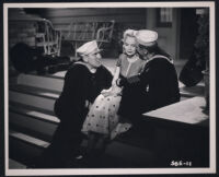 Groucho Marx whispers to Marie Wilson as William Bendix looks on in a scene from A Girl in Every Port