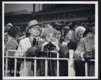 Gene Lockhart and George E. Stone watch the races with extras in A Girl in Every Port