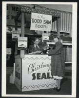 Cast members at the Christmas Seals charity booth on the set of Good Sam