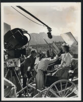 Actor, Randolph Scott, cinematographer, Fred Jackman, Jr. and actress, Dorothy Hart, prepare for a scene in Gunfighters