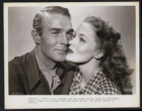 Randolph Scott and Dorothy Hart share a moment on the set of Gunfighters