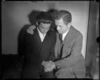 Louis Rude Payne is comforted by his father Lucius Payne on the day of his inquest. June 6, 1934.