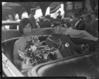 Prince and Princess Kaya of Japan ride in a vehicle through a crowd, Los Angeles, 1934