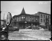 Vehicles cross flood waters at 7th and Wall Street, 1935