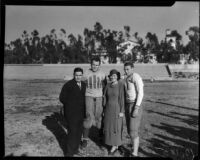 Coach Thomas and Mildred Cowan on football field with Alabama Crimson Tide players Bill Lee and Dixie Howell, Tuscaloosa, 1934-1935