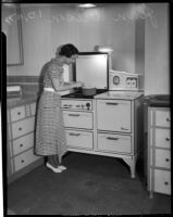 Jean Wilson cooks at a stove, Los Angeles, 1930s