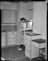Jean Wilson serves drinks in a kitchen, Los Angeles, 1930s