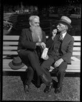 Two unidentifed men share a box of Cracker Jack during the annual Iowa Picnic, Los Angeles, 1930s