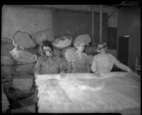 Women in masks make mattresses through SERA program, Los Angeles, 1935