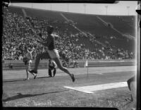 Jesse Owens competes in a broad jump event at a track meet, Los Angeles, 1930s