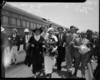 Evangelists Aimee Crawford and Rheba Crawford link arms in front of a crowd, Los Angeles, 1934