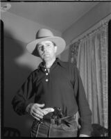 Dr. Ralph Wagner poses with a gun and hat, Los Angeles, 1930s