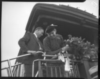 Eleanor Roosevelt receives welcome bouquet upon arrival at Central Station, Los Angeles, October 1, 1935