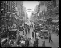 Crowds and traffic stop to watch President Franklin D. Roosevelt’s motorcade in downtown Los Angeles, October 1, 1935