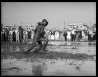 Mud covered students race at Los Angeles Junior College, February 1936
