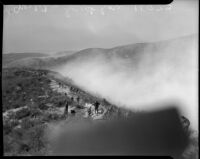 Fire fighters battle blaze in Malibu, circa October 1935