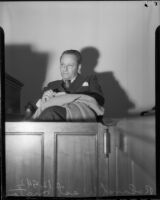 Director Roland West testifying at grand jury investigation into death of actress Thelma Todd, circa 1935