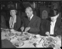 William Gibbs McAdoo at dinner event with two unknown women