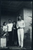 Aldous and Maria Huxley with an unidentified man and woman in front of house [descriptive]