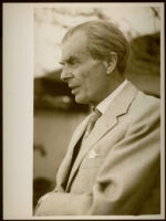 Aldous Huxley profile, dressed in light-colored suit and tie [descriptive]