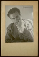 Aldous Huxley portrait, hand to cheek, wearing tweed blazer, in writing studio, Llano CA [descriptive]