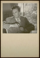 Aldous Huxley holding a pen and wearing a tweed blazer, in writing studio, Llano CA [descriptive]