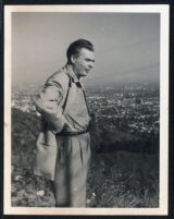 Aldous Huxley, standing in profile in hills above Hollywood [descriptive]