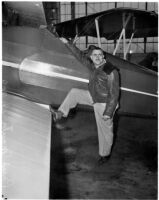 Paul Mantz, motion picture stunt pilot and consultant, poses with airplane.  Circa February 1936.