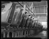 Line of Studebaker radiator grilles, affixed with hood ornaments, at Studebaker's Los Angeles assembly plant. circa January 2, 1936.