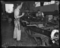 Men at work at the Los Angeles Studebaker assembly plant in Vernon, CA.  Circa January 2, 1936.